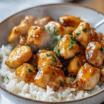 Honey Garlic Chicken Bites garnished with parsley and red pepper flakes.