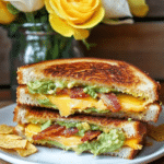 A Bacon Guacamole Grilled Cheese Sandwich served on a plate, ready to be enjoyed.