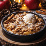 A serving of Pumpkin Crisp with a scoop of vanilla ice cream.