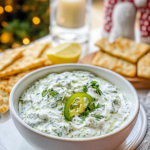 Tzatziki served as a dip with pita bread and vegetable sticks.