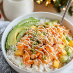 Mixing the imitation crab, mango, cucumber, and dressing together in a bowl for the Crab Rice Bowl topping.