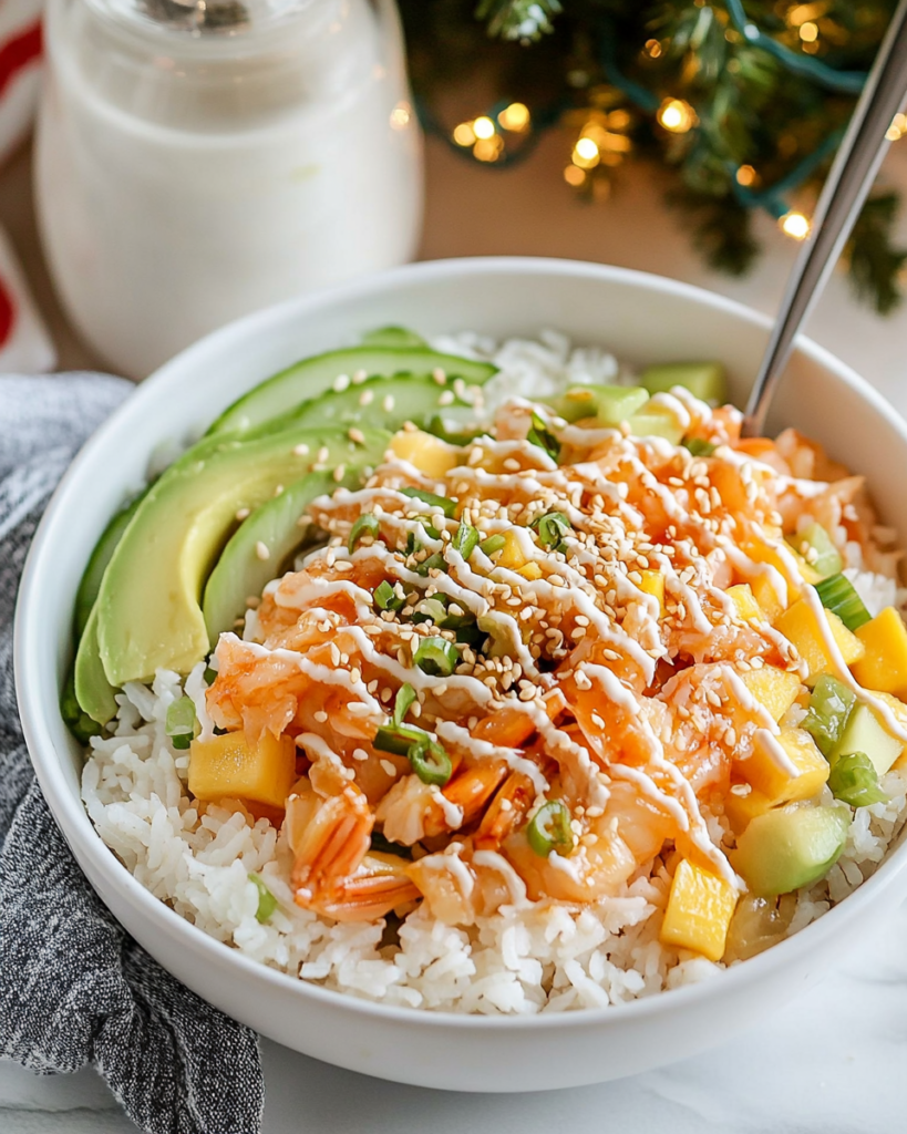 Mixing the imitation crab, mango, cucumber, and dressing together in a bowl for the Crab Rice Bowl topping.