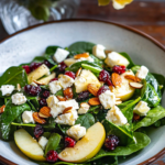 An individual serving of Apple Feta Spinach Salad on a plate.
