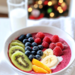 Blending the pink smoothie base in a high-speed blender for the Rainbow Smoothie Bowl.