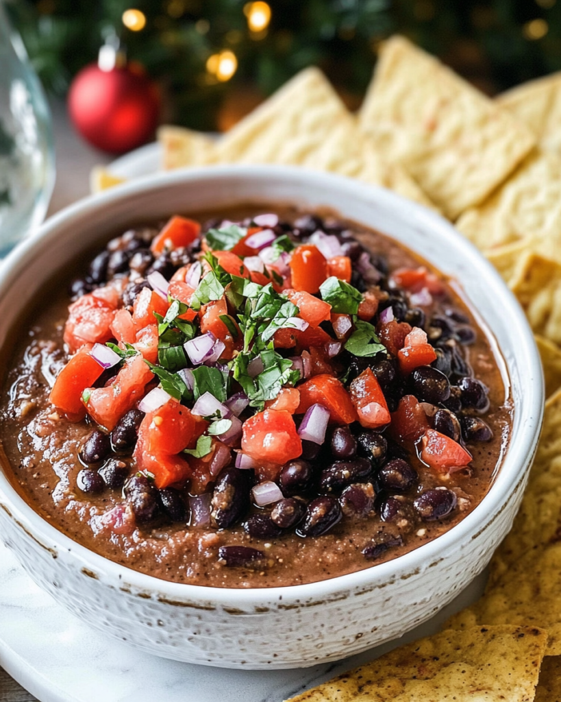 Ingredients for Black Bean Dip, including black beans, tomatoes, red onion, lime, cilantro/basil, and cumin.