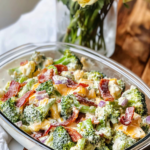 Individual meal prep containers filled with Creamy Broccoli Salad.