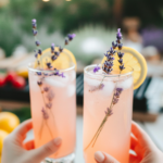 Glasses filled with Lavender Lemonade and ice, garnished with lemon and lavender.
