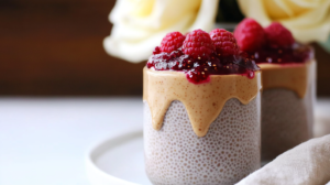 Layered Peanut Butter & Jam Chia Pudding parfaits in glass jars or cups.