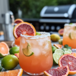 Pouring the shaken tequila and juice mixture into an ice-filled, salt-rimmed glass before topping with beer for the Beer Paloma.