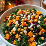 Massaging chopped kale with dressing in a large bowl for the Sweet Potato Kale Salad.