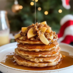 A close-up of Apple Crisp Pancakes showing the fluffy texture, apple pieces, and crunchy streusel topping.