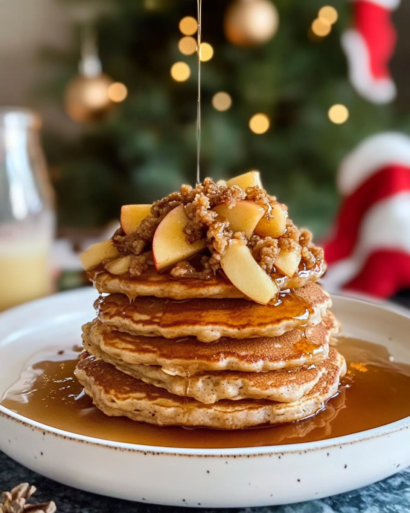 A close-up of Apple Crisp Pancakes showing the fluffy texture, apple pieces, and crunchy streusel topping.