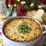 Jalapeño Popper Chorizo Dip being scooped with a tortilla chip, showing the cheesy texture.