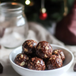 Ingredients for Chocolate Espresso Energy Bites, including dates, almonds, pecans, cocoa powder, espresso powder, almond butter, and dark chocolate.