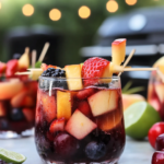 Fresh fruit pieces marinating in a bowl of red wine sangria before being skewered.