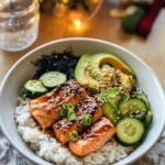 Assembling a Salmon Sushi Bowl by arranging broiled salmon and fresh toppings over sushi rice.