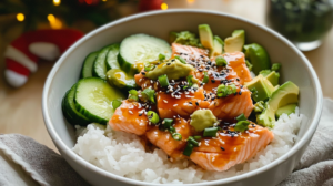 A vibrant Salmon Sushi Bowl showing broiled salmon, sushi rice, avocado, cucumber, nori, and sriracha mayo drizzle.