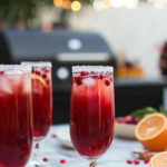 Rimming a champagne flute with vanilla bean sugar for Blood Orange Mimosas.
