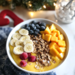 Blending the frozen fruit and milk in a high-speed blender for the Mango Smoothie Bowl.