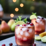 Making sugared cranberries by rolling syrup-coated cranberries in sugar for the Cranberry Pear Moscow Mule garnish.
