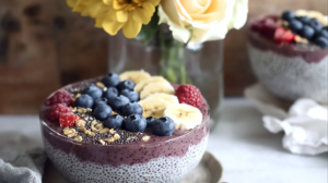 A vibrant Acai Chia Pudding Bowl showing the distinct purple smoothie and lighter chia pudding sides, artfully decorated with various toppings.