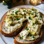 Blending the warm artichoke and cheese mixture in a food processor until smooth for Artichoke Bruschetta.