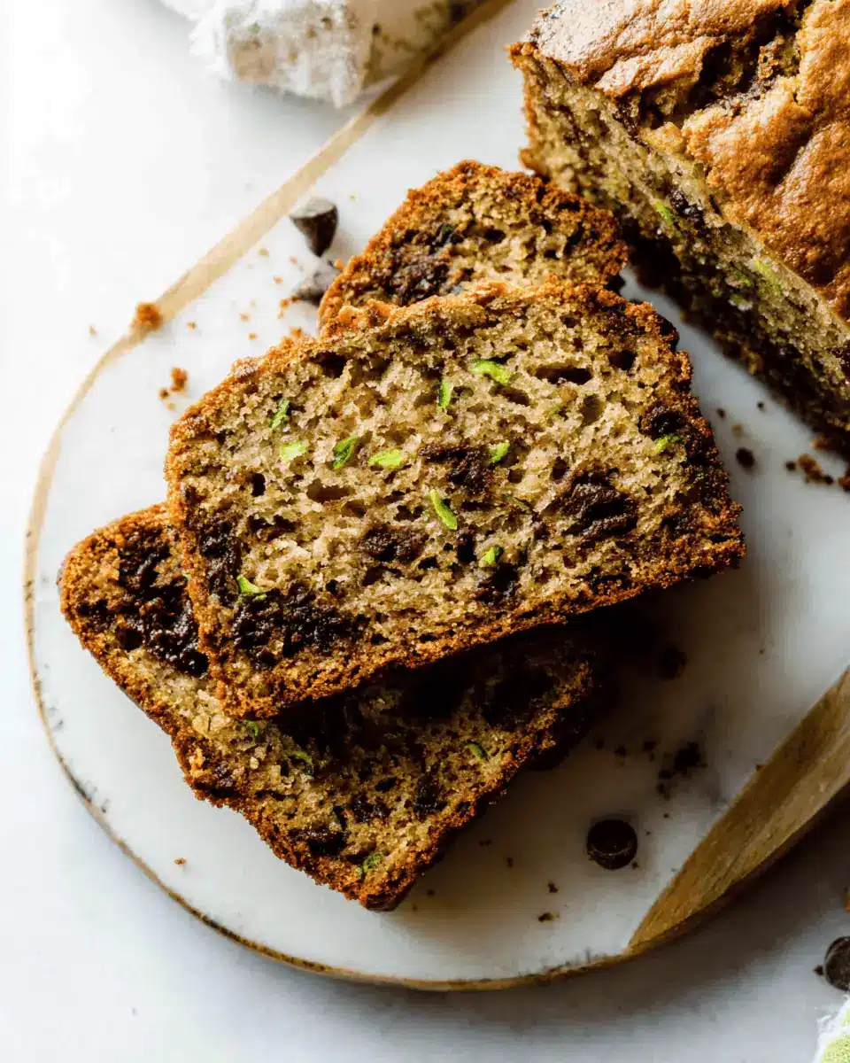 A single, thick slice of moist zucchini bread showing a tender crumb.