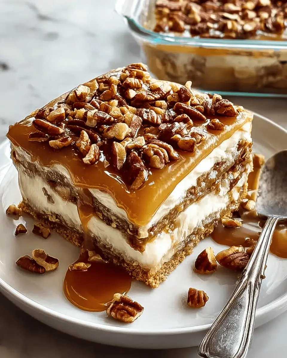 Perfect No-Bake Pecan Pie Lasagna (Easy Holiday Dessert!) 3 A perfect square slice of pecan pie lasagna on a dessert plate, showing all four distinct layers.