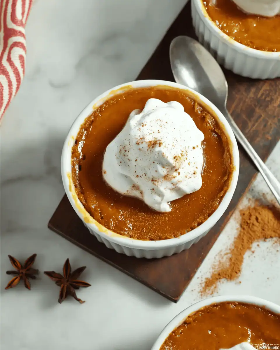 Easy Mini Crustless Pumpkin Pies (Silky Custard!) 3 A single white ramekin of smooth, crustless pumpkin pie, topped with a large dollop of whipped cream.