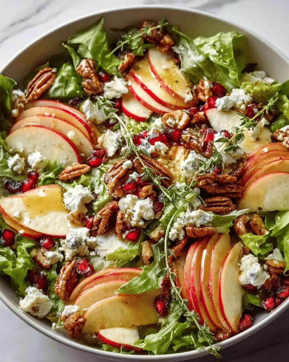 Autumn Harvest Apple Feta Salad (with Honey-Cider Vinaigrette) 1 A close-up shot of the apple feta salad, highlighting the crumbled feta and pomegranate seeds.
