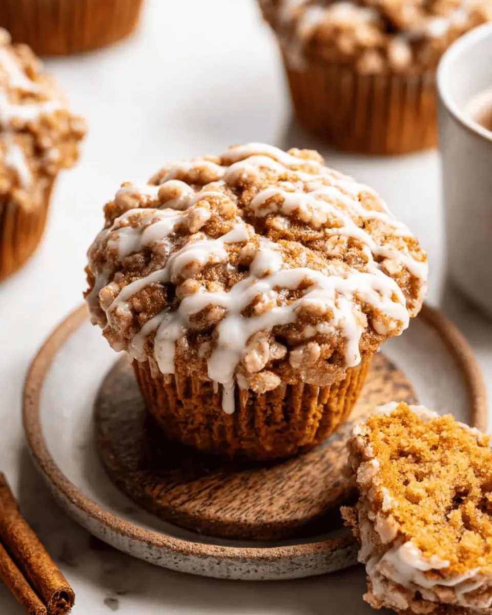 The Best Bakery-Style Pumpkin Streusel Muffins (Maple Glaze!) 3 A dozen freshly baked pumpkin streusel muffins cooling on a black wire rack before being glazed.