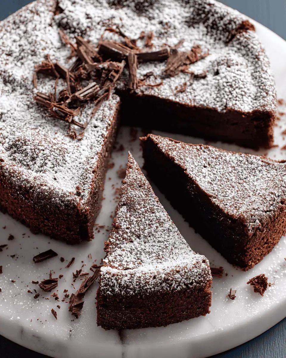 Flourless Chocolate Torte: A Fudgy and Elegant Gluten-Free Dessert 2 A slice of dense flourless chocolate torte on a plate served with fresh raspberries and whipped cream.