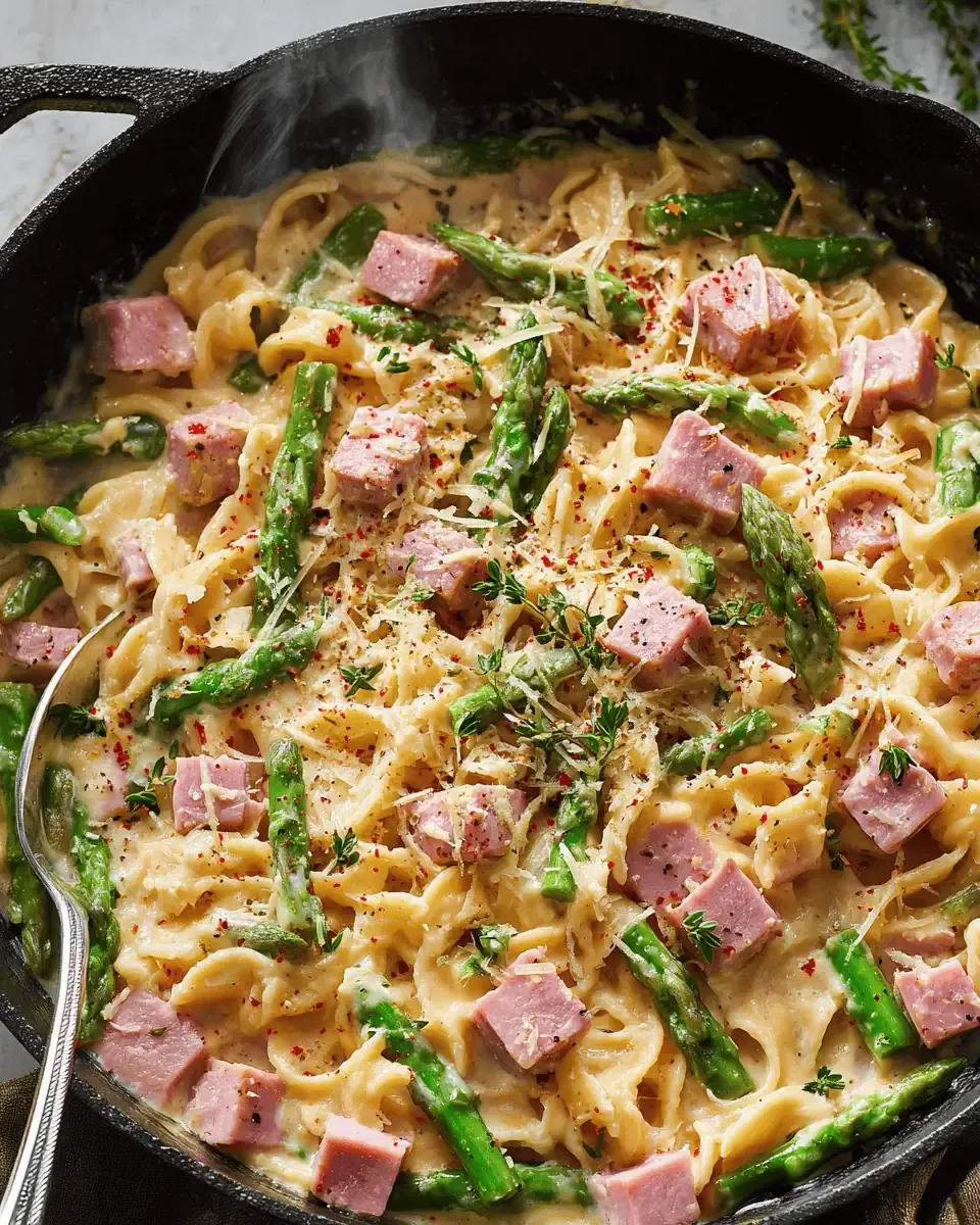 Creamy Ham Pasta with Asparagus: A 30-Minute Dinner 1 Cubed leftover ham and trimmed asparagus on a cutting board.