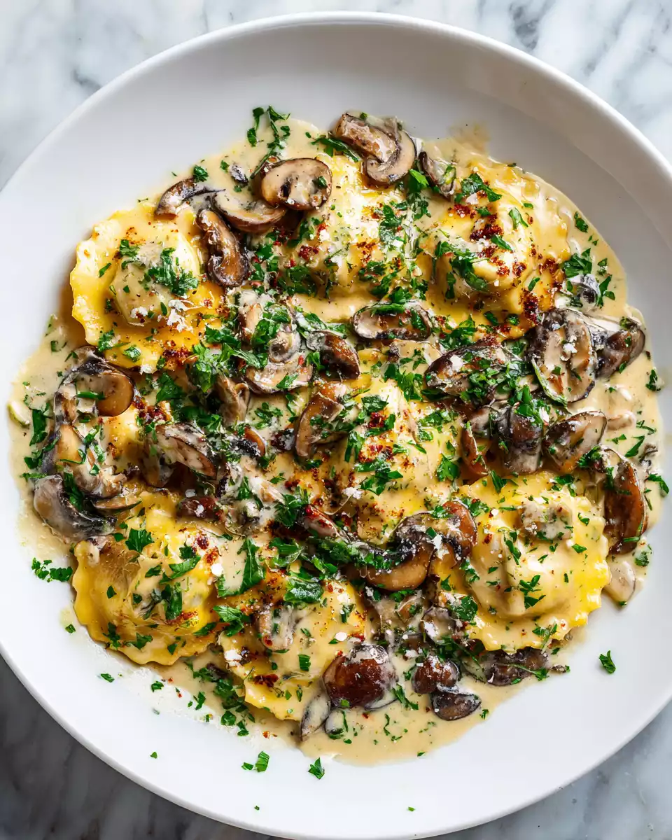 Mushroom Ravioli with Creamy Mushroom Sauce 2 Delicious mushroom ravioli served with rich cream sauce and garnished with parsley, a perfect vegetarian dish for any occasion.