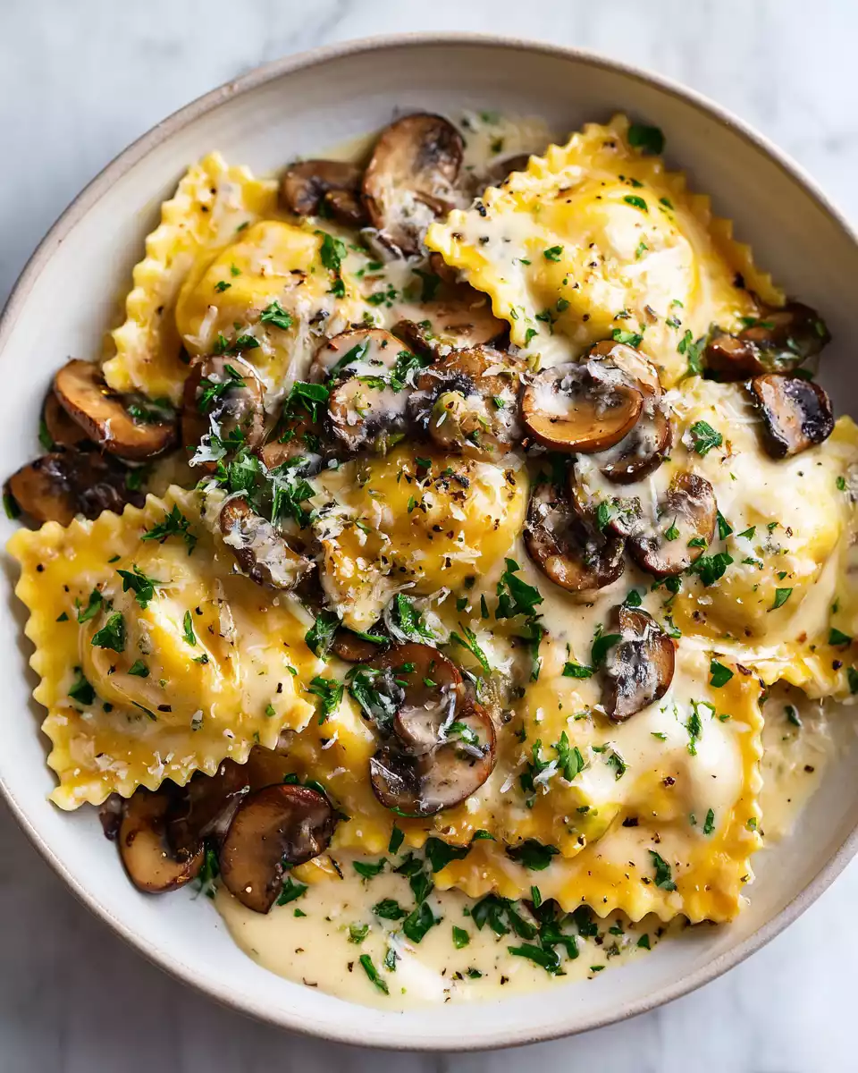Mushroom Ravioli with Creamy Mushroom Sauce 4 Delicious mushroom ravioli served with rich cream sauce and garnished with parsley, a perfect vegetarian dish for any occasion.