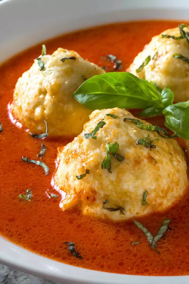 Cheese dumpling tomato soup with tender dumplings in rich tomato broth, perfect for comfort food lovers.